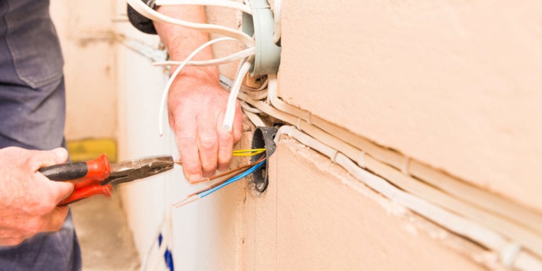 Person crimping electrical wires